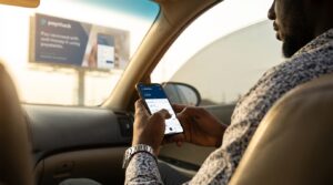 A man using a phone inside a car