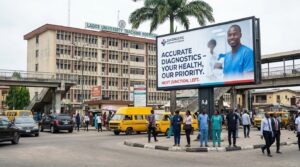 An image showing a billboard placed near a hospital building