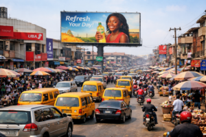 A large billboard around commercial buildings, bank branches, and market stalls