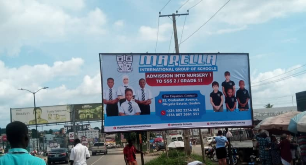 Billboard in Ibadan, Oyo State, at Mobil Ring Road opposite Dominos Pizza, facing Mobil to Town Planning